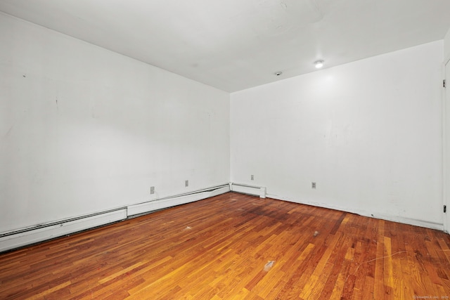 21 Gilbert Hill Rd, Norwalk, CT 06853 - spare room featuring wood finished floors and a baseboard heating unit