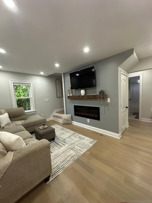 60 Carlson Ave, Bridgeport, CT 06606 - living room with light wood-type flooring, a glass covered fireplace, and recessed lighting