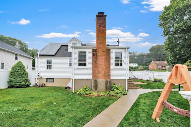 1462 Cutspring Rd, Stratford, CT 06614 - rear view of house featuring a chimney and solar panels