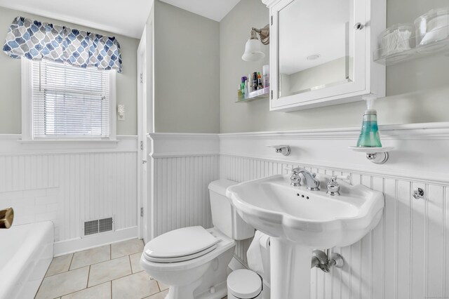 1462 Cutspring Rd, Stratford, CT 06614 - full bath featuring wainscoting, a tub, and tile patterned flooring