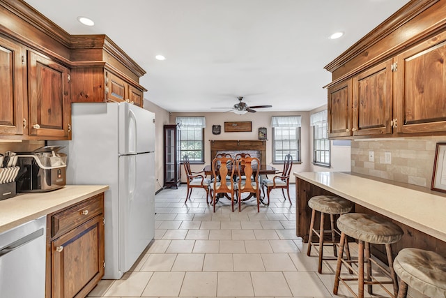 1462 Cutspring Rd, Stratford, CT 06614 - kitchen with ceiling fan, dishwasher, recessed lighting, backsplash, and freestanding refrigerator