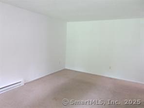 7 Padanaram Rd Unit I184, Danbury, CT 06811 - carpeted spare room featuring a baseboard heating unit