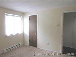 7 Padanaram Rd Unit I184, Danbury, CT 06811 - unfurnished bedroom featuring baseboard heating and carpet floors