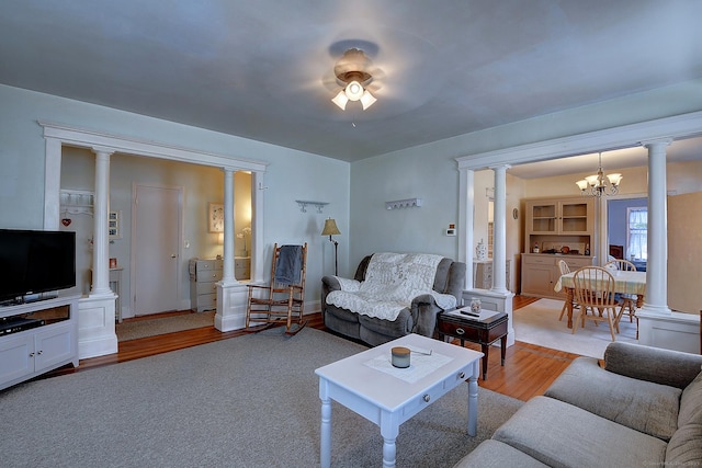 32 Columbus St, East Hartford, CT 06108 - living room featuring a chandelier, light wood finished floors, and decorative columns
