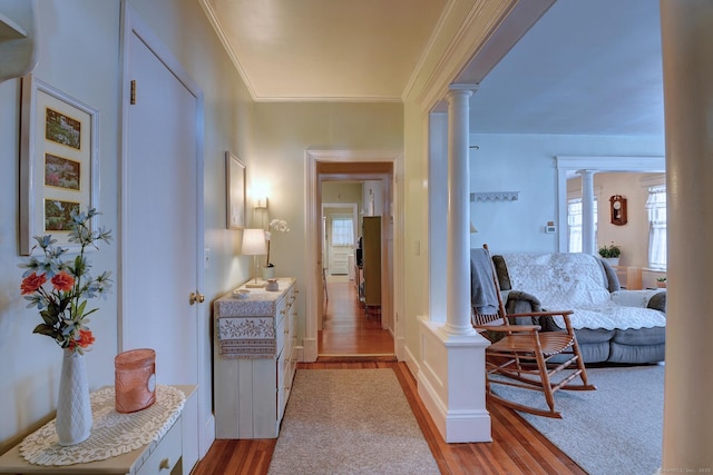 32 Columbus St, East Hartford, CT 06108 - hallway featuring ornate columns, light wood-style flooring, and crown molding