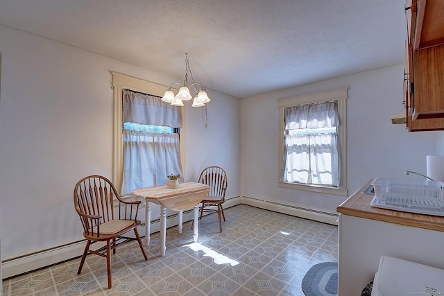 32 Columbus St, East Hartford, CT 06108 - dining room featuring a chandelier, a baseboard radiator, light flooring, and a textured ceiling