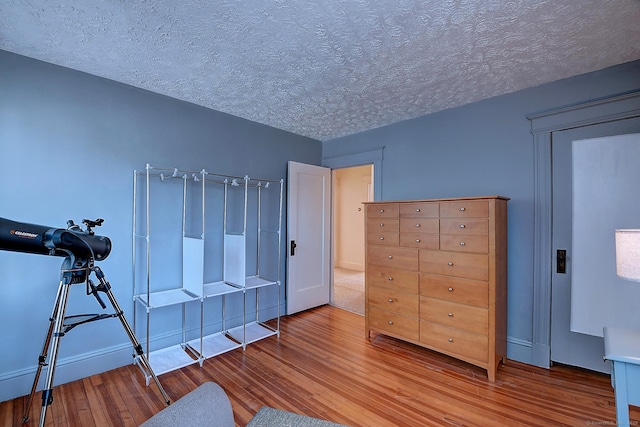 32 Columbus St, East Hartford, CT 06108 - bedroom featuring wood finished floors and a textured ceiling