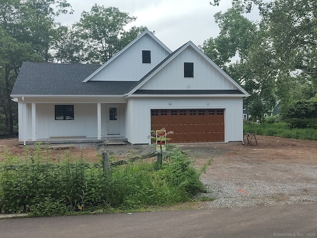 26 Depot Rd, Haddam, CT 06441 - modern farmhouse style home with dirt driveway, a porch, roof with shingles, and an attached garage