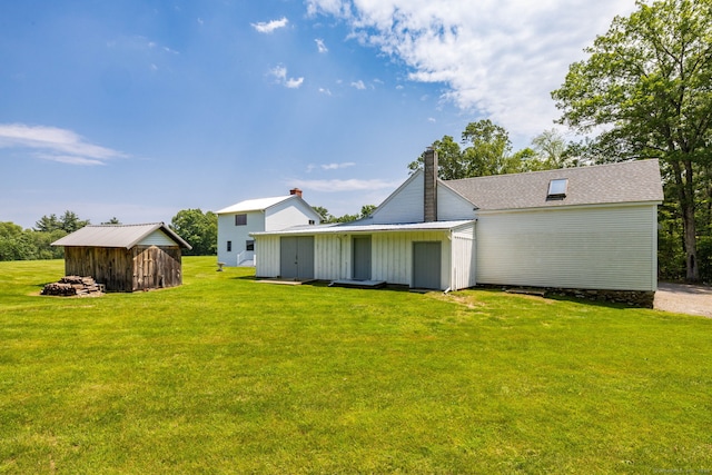 1669 Rte 169, Woodstock, CT 06281 - rear view of house featuring a yard, a shed, and a chimney