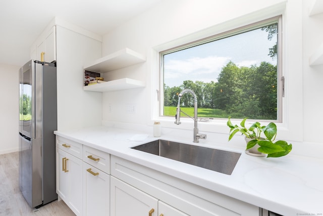 1669 Rte 169, Woodstock, CT 06281 - kitchen with freestanding refrigerator, light wood-style flooring, white cabinetry, and light stone counters