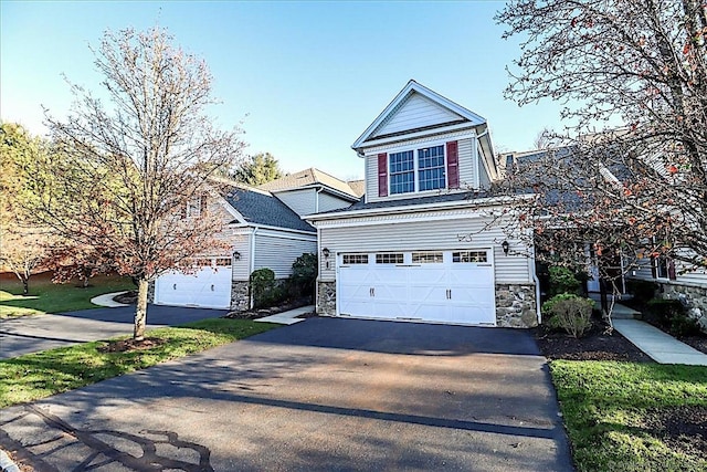 66 Watkins Dr Unit 66, Newtown, CT 06482 - view of front of house featuring asphalt driveway, an attached garage, and stone siding