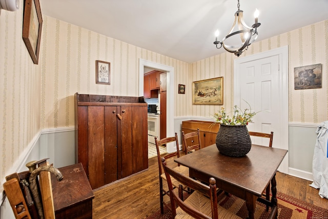 1775 Orchard Hill Rd, Cheshire, CT 06410 - dining area with wood finished floors, a chandelier, wallpapered walls, and a wainscoted wall