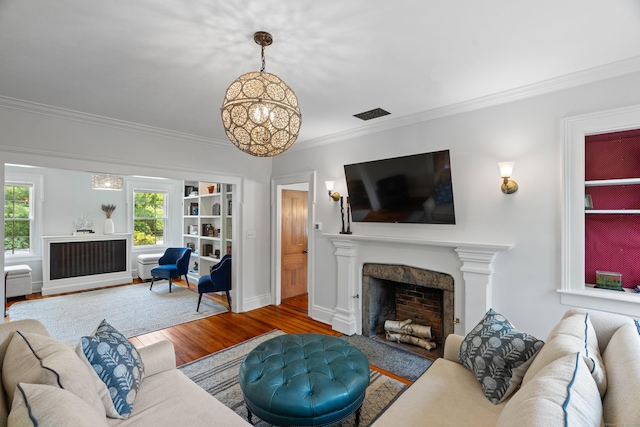 109 Boston Post Rd, Madison, CT 06443 - living room with a fireplace, ornamental molding, a chandelier, and wood finished floors