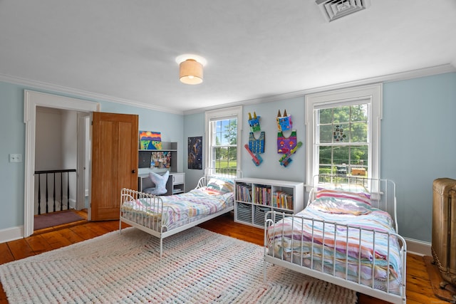 109 Boston Post Rd, Madison, CT 06443 - bedroom with hardwood / wood-style floors, radiator heating unit, and ornamental molding