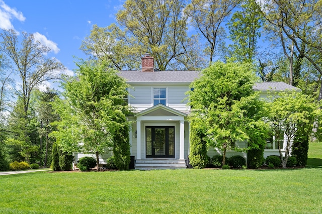 289 Wahackme Rd, New Canaan, CT 06840 - view of front of home with a front yard, a chimney, and a shingled roof
