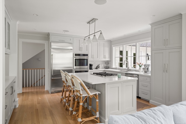 289 Wahackme Rd, New Canaan, CT 06840 - kitchen with stainless steel appliances, light countertops, tasteful backsplash, ornamental molding, and a kitchen bar