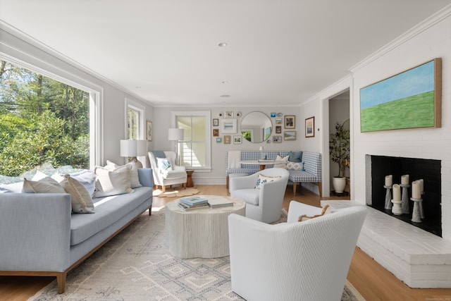 289 Wahackme Rd, New Canaan, CT 06840 - living room featuring healthy amount of natural light, a brick fireplace, crown molding, and light wood-style floors
