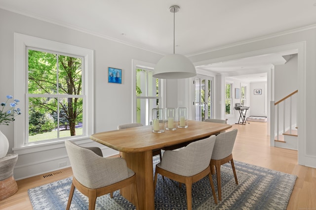 289 Wahackme Rd, New Canaan, CT 06840 - dining area featuring stairway, healthy amount of natural light, light wood-style flooring, and ornamental molding