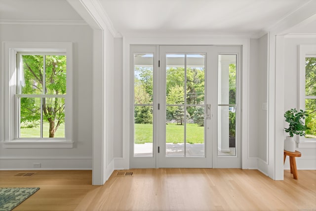 289 Wahackme Rd, New Canaan, CT 06840 - doorway to outside with light wood-style flooring, healthy amount of natural light, and ornamental molding