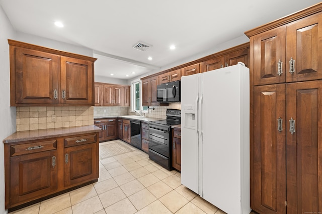 170 Southern Blvd, Danbury, CT 06810 - kitchen with black appliances, backsplash, light tile patterned floors, recessed lighting, and brown cabinetry