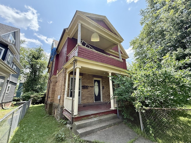 338 Sigourney St, Hartford, CT 06112 - view of front of home with brick siding and a porch