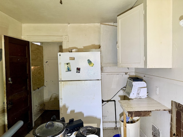 338 Sigourney St, Hartford, CT 06112 - kitchen with freestanding refrigerator and white cabinetry