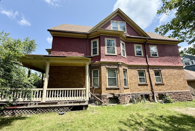 338 Sigourney St, Hartford, CT 06112 - back of property featuring a yard, brick siding, and covered porch