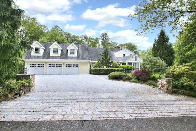 29 Bradley Rd, Weston, CT 06883 - view of front facade with decorative driveway and an attached garage