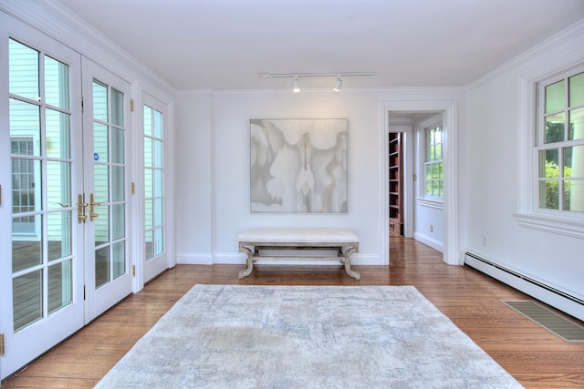 29 Bradley Rd, Weston, CT 06883 - sitting room with baseboard heating, french doors, wood finished floors, track lighting, and plenty of natural light