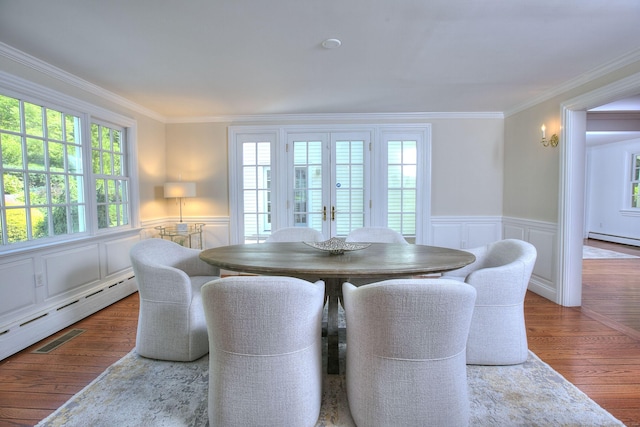 29 Bradley Rd, Weston, CT 06883 - dining area featuring wood finished floors, crown molding, a decorative wall, wainscoting, and a baseboard heating unit