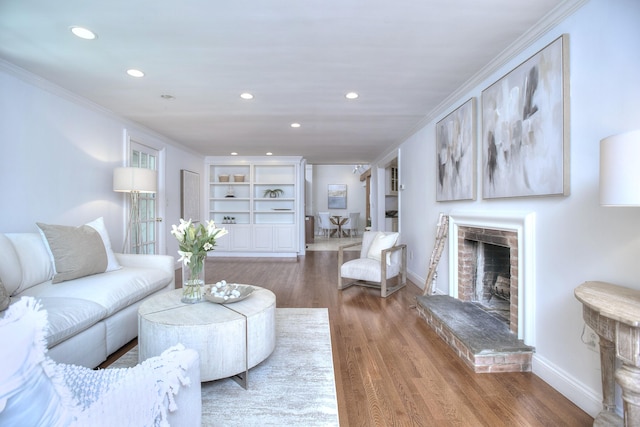 29 Bradley Rd, Weston, CT 06883 - living area with a fireplace, ornamental molding, recessed lighting, and wood finished floors