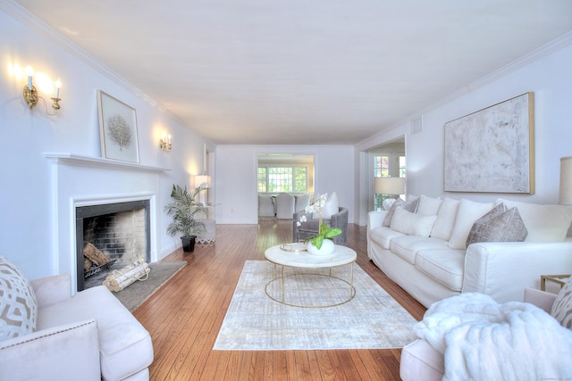 29 Bradley Rd, Weston, CT 06883 - living area featuring a fireplace with flush hearth, hardwood / wood-style flooring, and ornamental molding