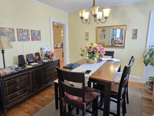 48 Scott St, East Hartford, CT 06118 - dining space with a chandelier, dark wood-style flooring, and crown molding