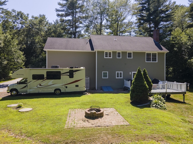 18 Jeans Ct, Woodstock, CT 06281 - rear view of property with a fire pit, a chimney, a deck, and a lawn