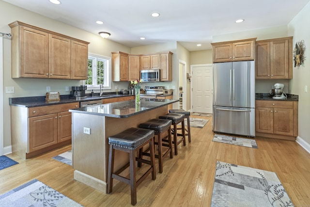 18 Jeans Ct, Woodstock, CT 06281 - kitchen featuring appliances with stainless steel finishes, light wood-style floors, a kitchen bar, a kitchen island, and recessed lighting