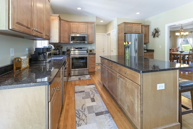 18 Jeans Ct, Woodstock, CT 06281 - kitchen with appliances with stainless steel finishes, light wood-type flooring, a center island, a chandelier, and dark stone counters