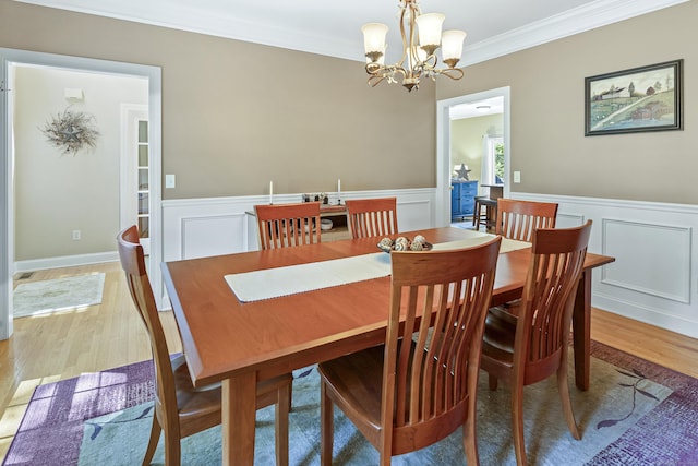 18 Jeans Ct, Woodstock, CT 06281 - dining space featuring ornamental molding, light wood-type flooring, a decorative wall, a chandelier, and wainscoting