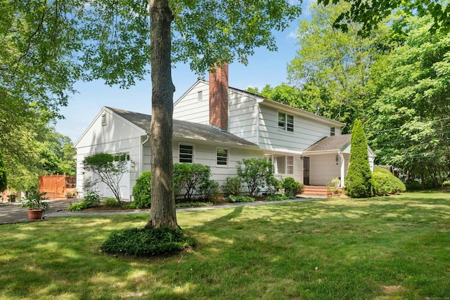 11 Old Kings Hwy, New Canaan, CT 06840 - back of house with a lawn, a chimney, roof with shingles, and a garage