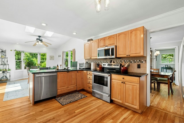 11 Old Kings Hwy, New Canaan, CT 06840 - kitchen featuring stainless steel appliances, light wood-style flooring, a skylight, plenty of natural light, and vaulted ceiling