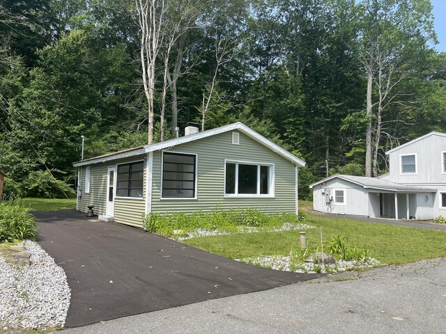 538 Winthrop Rd, Deep River, CT 06417 - view of side of property featuring a yard, a chimney, and asphalt driveway
