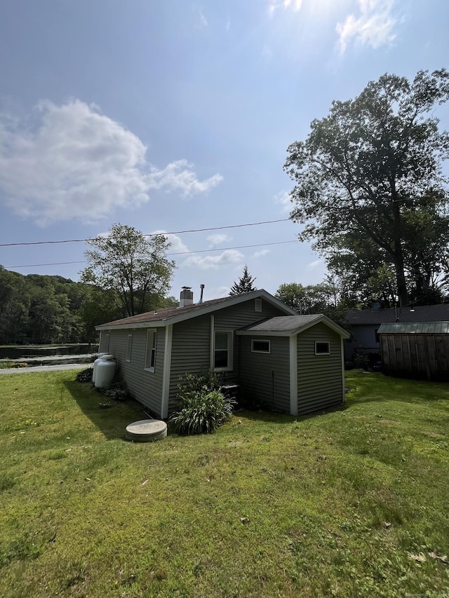 538 Winthrop Rd, Deep River, CT 06417 - rear view of property with a chimney, a yard, and an outdoor structure