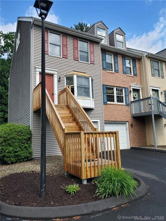 1275 Winsted Rd Unit 101, Torrington, CT 06790 - view of front of property with a garage and asphalt driveway