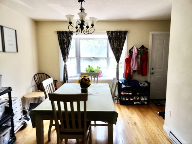 1275 Winsted Rd Unit 101, Torrington, CT 06790 - dining space with a chandelier, light wood finished floors, and a baseboard heating unit