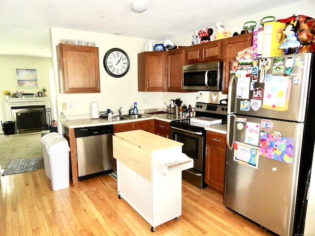1275 Winsted Rd Unit 101, Torrington, CT 06790 - kitchen with stainless steel appliances, light countertops, light wood-style flooring, and a kitchen island