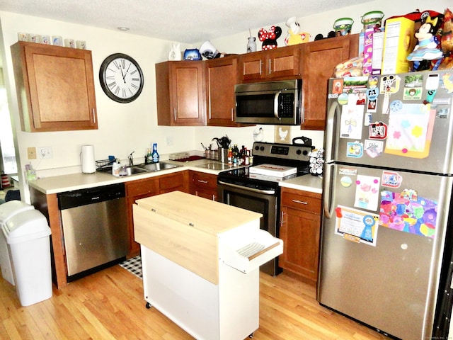 1275 Winsted Rd Unit 101, Torrington, CT 06790 - kitchen with appliances with stainless steel finishes, light wood-style floors, light countertops, and a center island