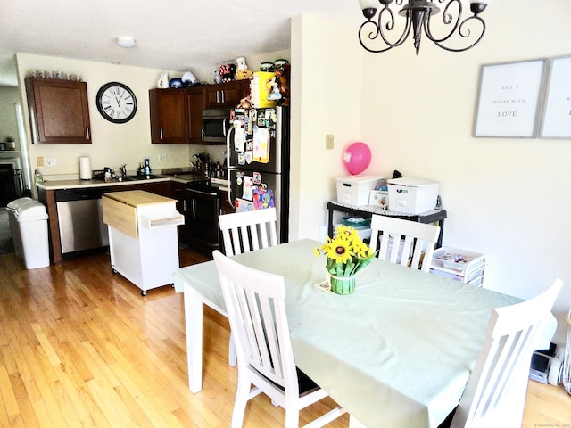 1275 Winsted Rd Unit 101, Torrington, CT 06790 - dining room featuring a chandelier and light wood-type flooring