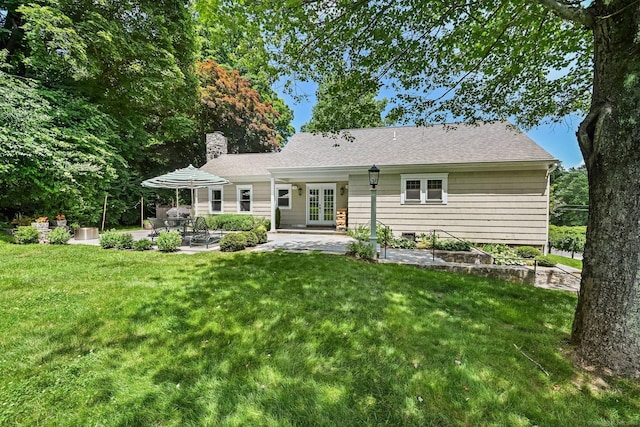 311 Wilton Rd E, Ridgefield, CT 06877 - back of property featuring french doors, a patio, a lawn, and a chimney