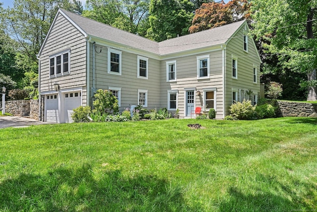 311 Wilton Rd E, Ridgefield, CT 06877 - colonial-style house featuring a garage, asphalt driveway, and a front lawn