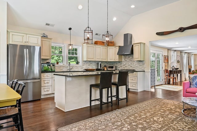 311 Wilton Rd E, Ridgefield, CT 06877 - kitchen featuring freestanding refrigerator, wall chimney range hood, plenty of natural light, backsplash, and recessed lighting