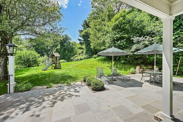 311 Wilton Rd E, Ridgefield, CT 06877 - view of patio with a playground, outdoor dining space, and view of wooded area